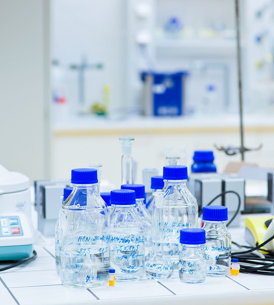 female researcher carrying out research experiments in a chemistry lab (color toned image)